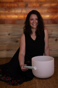 Dr Jaie in the salt cave with a singing bowl