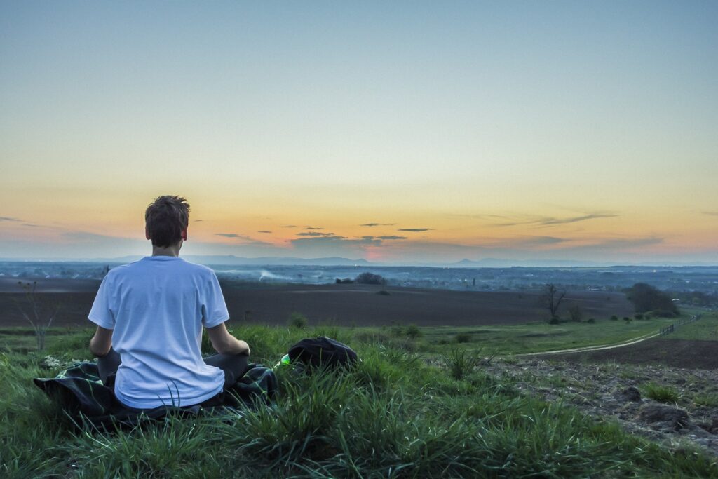 Human Meditating at sunrise