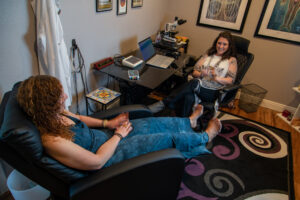Jamie talking with a client during biofeedback session